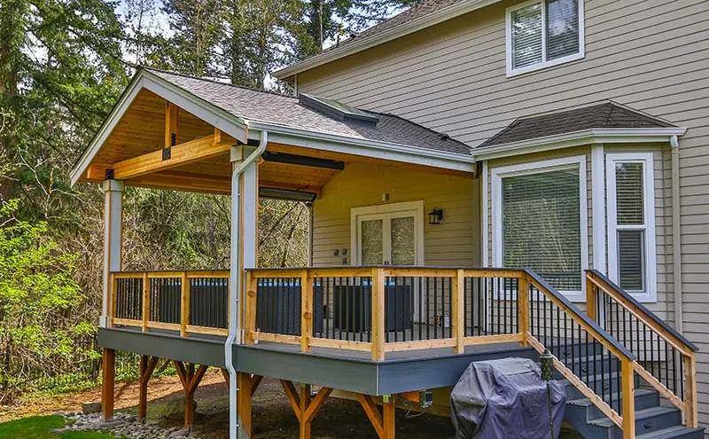 Cedar posts and rails with metal pickets on a covered deck